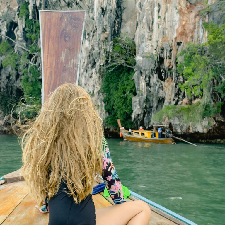 Longtail boat Krabi, Thailand with limestone cliffs
