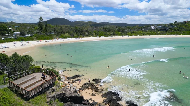 Aerial view of Scoots Head Beach with turquoise water, sandy shoreline and coastal headland on the Mid North Coast NSW