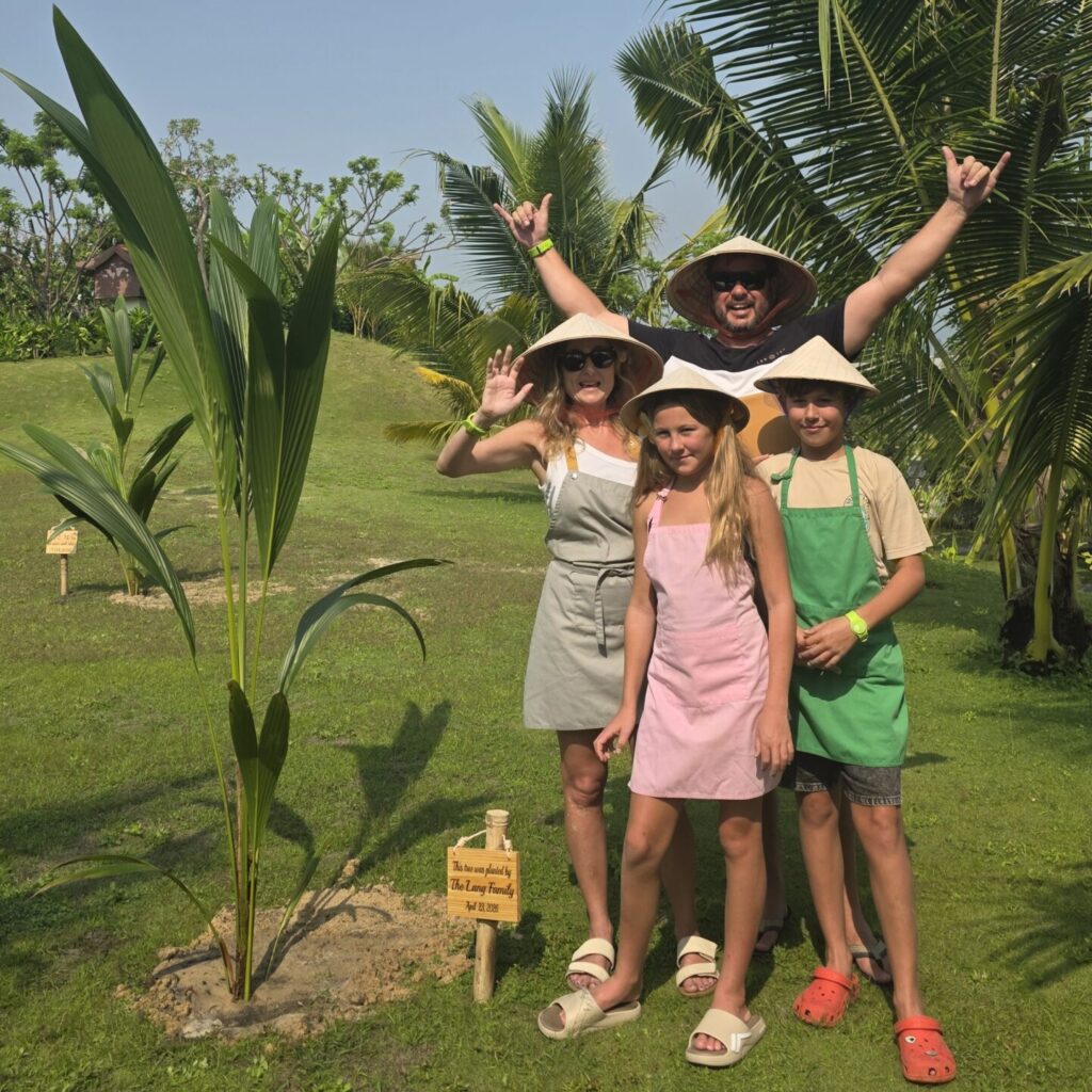 Family planting a tree together at Alma Resort in Camh Ranh, Vietnam