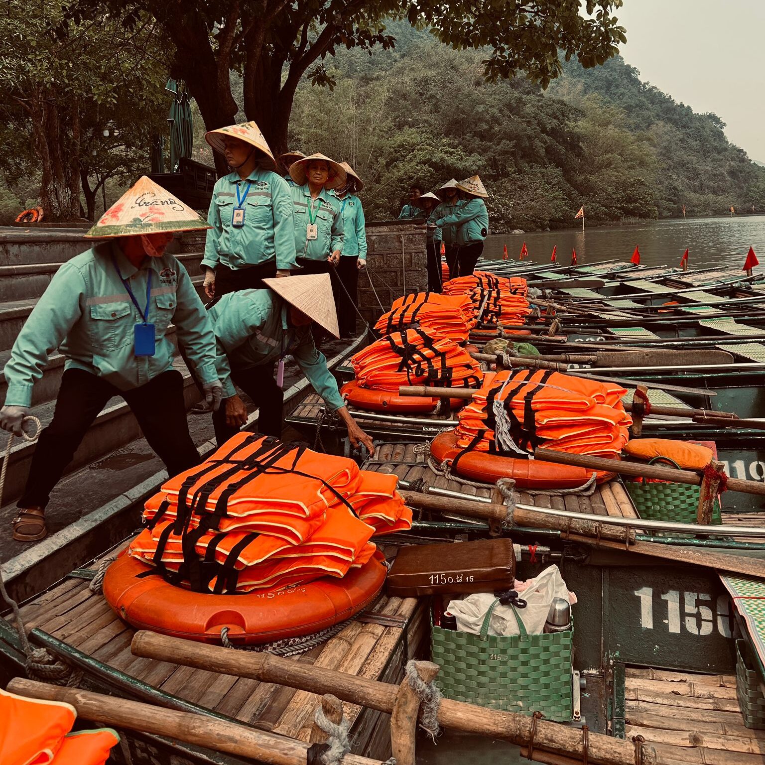 Boat tour guides preparing boats at Trang An, Ninh Binh, Vietnam