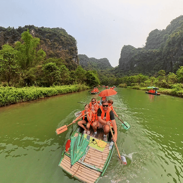 Family boat trip through the limestone karsts of Trang An, Ninh Binh, Vietnam